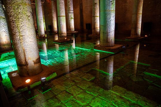  Ancient underground Basilica Cistern in Istanbul with stone columns and illuminated green water reflecting the architecture in a historical setting