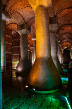 Ancient Byzantine cistern with large new columns and arches illuminated by colorful lights in Istanbul, Turkey, showcasing historical architecture