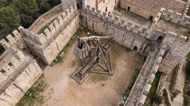 Aerial View of Medieval Castle Courtyard with Ancient Siege Weapon Display