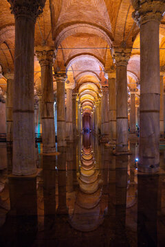 Architectural interior of the Basilica Cistern in Istanbul, featuring rows of columns and vaulted ceilings illuminated by warm lighting