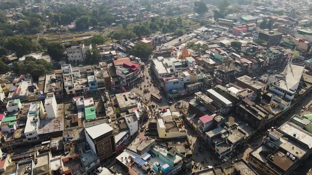 An aerial view of Dehradun, an Indian city during sunrise or sunset, with cloudy weather and rows of residential houses.