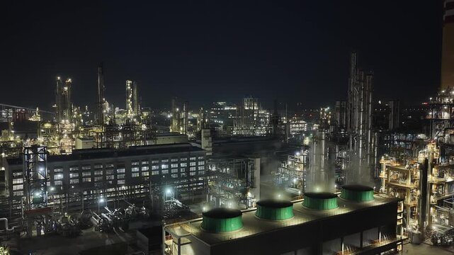 illuminated chemical industrial plant at night