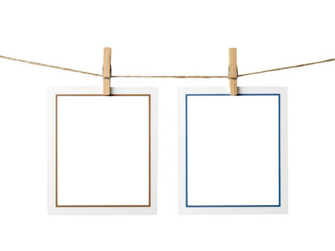 Two blank photo frames hanging on a rope isolated on transparent background