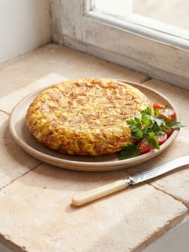 Spanish omelette with tomatoes and parsley