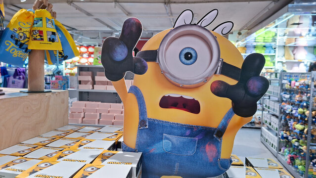 Cute yellow one eyed Minion character cardboard cutout display with shocked expression standing inside a mini mono store on September 8, 2026 in Bangkok, Thailand.