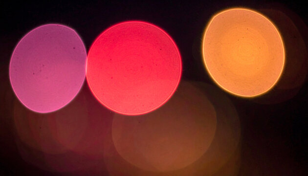 Abstract vintage pink orange red bokeh light circles on solid black background, soft glowing orbs texture, photorealistic defocused overlay effect Generative AI

