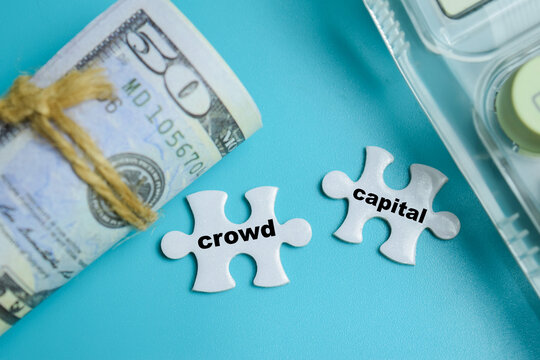 Piece of jigsaw puzzle crowd capital phrase. For equity crowdfunding and venture capital funding