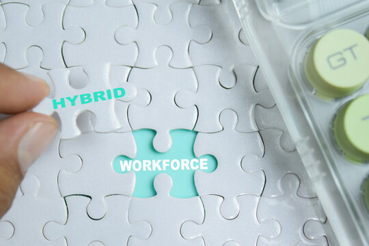 Piece of jigsaw puzzle hybrid workforce phrase. For modern business management and labor costs