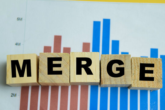 Concept of merge text on wooden blocks. For corporate consolidation and business strategy
