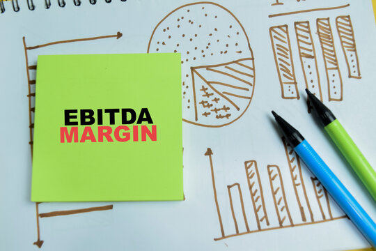 Concept of ebitda margin write on sticky notes isolated on table. For business profitability analysis