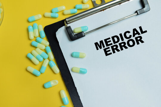 Concept of medical error write on clipboard isolated on table.
