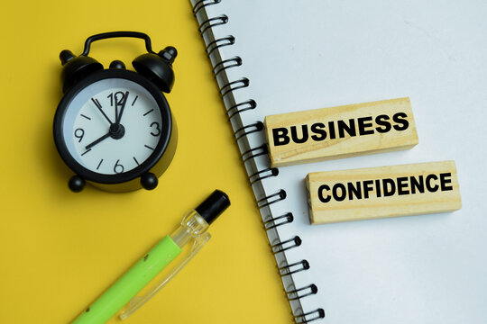 Concept of business confidence text on wooden blocks. For market optimism