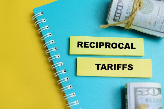 Concept of reciprocal tariffs write on sticky notes isolated on table. For international trade, import export tax policy and trade war