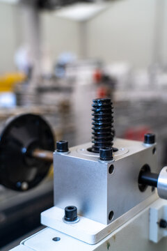 Industrial worm gear screw jack mechanism operating on an automated production line