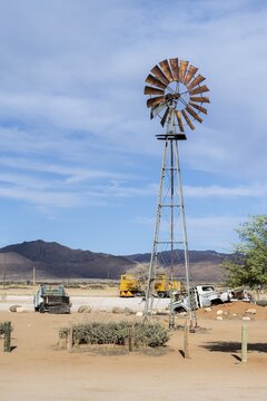 Windmill and car wreck of a vintage car, Solitaire, Khomas region, Namibia