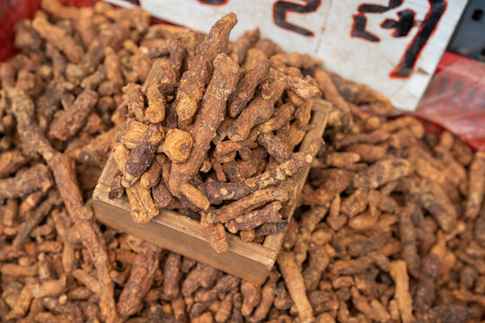 Dried Solomon seal roots heap inside a traditional wooden measuring box at a local market in South Korea.