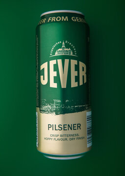 LONDON,UK - APRIL 10, 2026: Jever Pilsner lager beer on green background.Top view.
