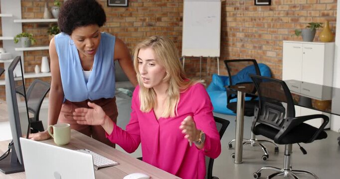 Lifestyle videos indoor of people doing activities at office, two businesswomen using computer in mo
