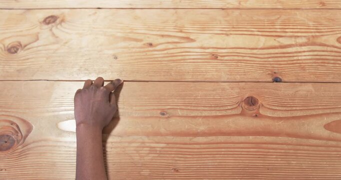 Close up of people talking to the camera, hand writing on wooden surface, creating business notes or