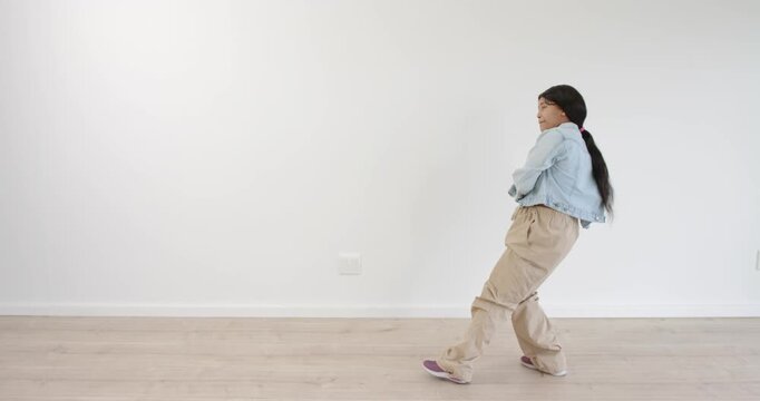 High-speed photography for dynamic scenes, walking indoors, girl in casual outfit pulling across emp