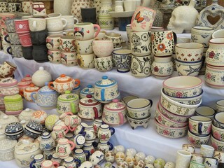 variety of traditional mexican clay pottery talavera cups - mugs- in a market