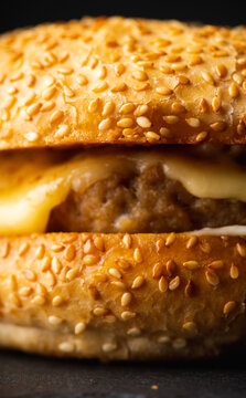 Cheeseburger on the rustic black table. Selective focus.