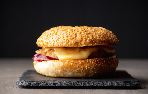 Cheeseburger on the rustic black table. Selective focus.