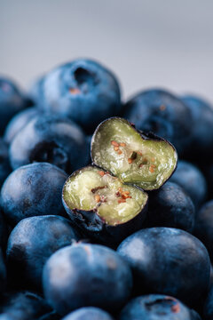 Fresh blueberries with one cut berry macro close up. Selective focus.