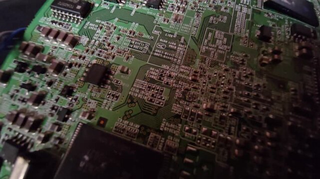 Close-up of a digital projector internal mainboard circuit with electronic microchips, capacitors, and IC components, highlighting optic engine and AV hardware technology.
