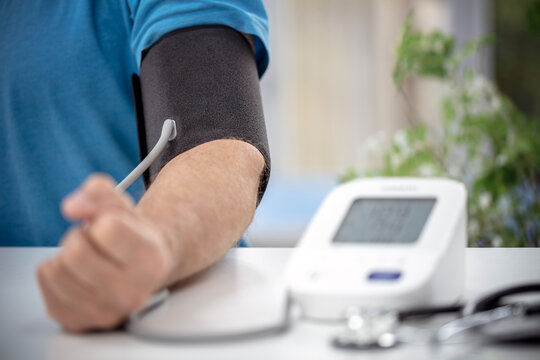 Doctor measuring blood pressure of patient in hospital