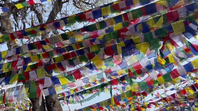 Buddhist prayer flags fluttering in the wind at Swayambhunath Stupa Complex in Kathmandu Nepal