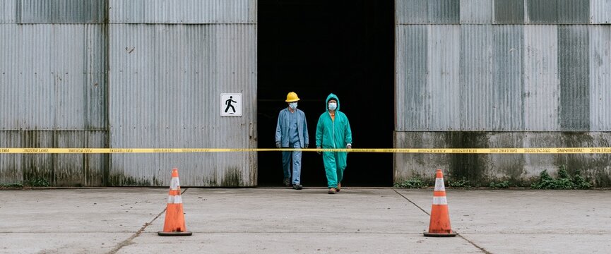Workers in protective gear at industrial site