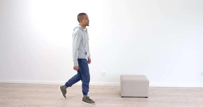 African American man exercising with step box at home, focusing on fitness routine