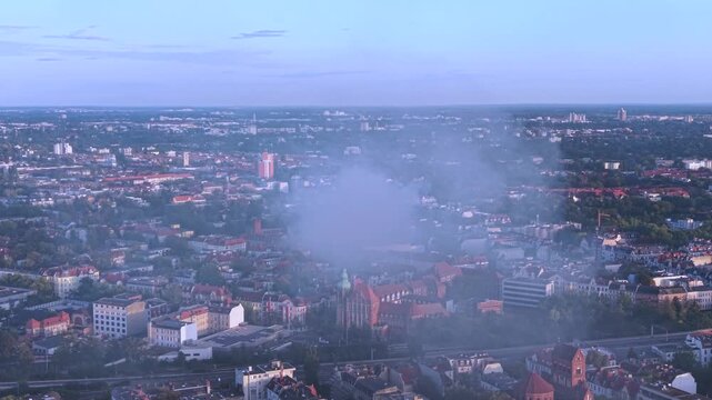 Smoke column rising over Berlin buildings, indicating a significant fire incident and potential infrastructure impact. Majestic aerial view drone panorama shot from above