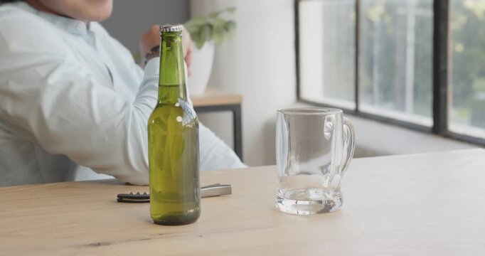 Pouring beer into glass mug at office, preparing for casual business gathering