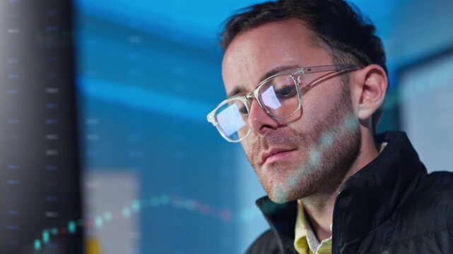 Close Up of Focused Male Trader Analyzing Stock Market Financial Charts