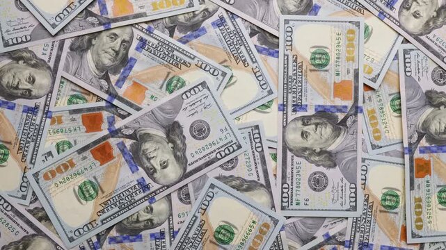 Benjamin franklin portrait closeup on bills hundred dollars rotates slow motion dollar