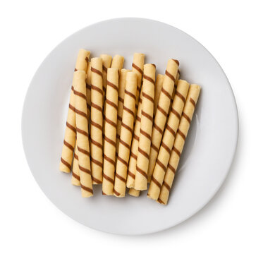 Wafer rolls on a plate on a white. Top view