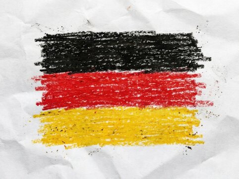 German flag drawn with crayon on crumpled paper with textured background and artistic effect