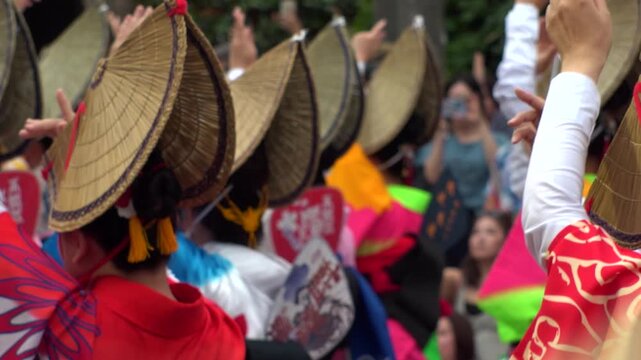 TOKYO, JAPAN - AUG 2026 : Slow motion shot of Awa Odori dance festival in Koenji. Powerful and energetic dance and music. Traditional Japanese summer event in Tokyo. Close up shot of lady dancer.