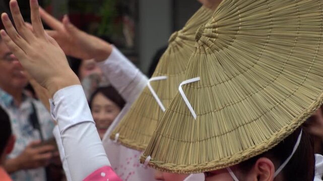 TOKYO, JAPAN - AUG 2026 : Slow motion shot of Awa Odori dance festival in Koenji. Powerful and energetic dance and music. Traditional Japanese summer event in Tokyo. Close up shot of lady dancer.