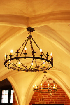 Warm glow dances from vintage chandeliers