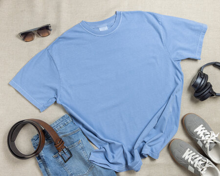 Blank light blue unisex t-shirt mockup, crewneck flat lay with denim jeans and mens accessories