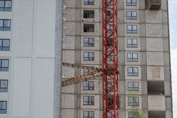 Construction of a modern building with cranes rising into the sky © beholdereye