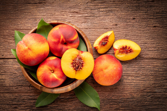 Orange Peach on the wooden basket over wooden table background, Fresh peach on wooden basket in wooden Background.