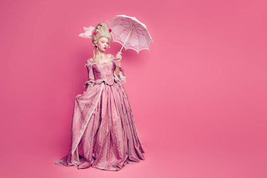 Full length photo of adorable attractive lady dressed baroque costume holding parasol copy space isolated pink color background