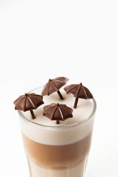 Layered Latte Topped with Mini Chocolate Umbrellas, Summer Coffee Concept