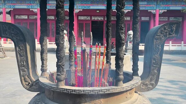 Incense and candles in front of the Mahavira Hall of Xiantong Temple, commonly known as Xiangshan Temple, which was first built in the Western Jin Dynasty. Huaibei City, Anhui Province, China.