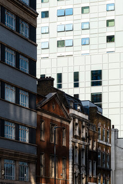 Layered older brick buildings and modern architecture in London England create an urban cityscape showing contrast between established and new development