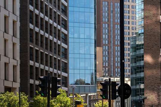 Layered modern buildings and towers in London England form a dense urban cityscape where varied architecture creates strong contemporary city density